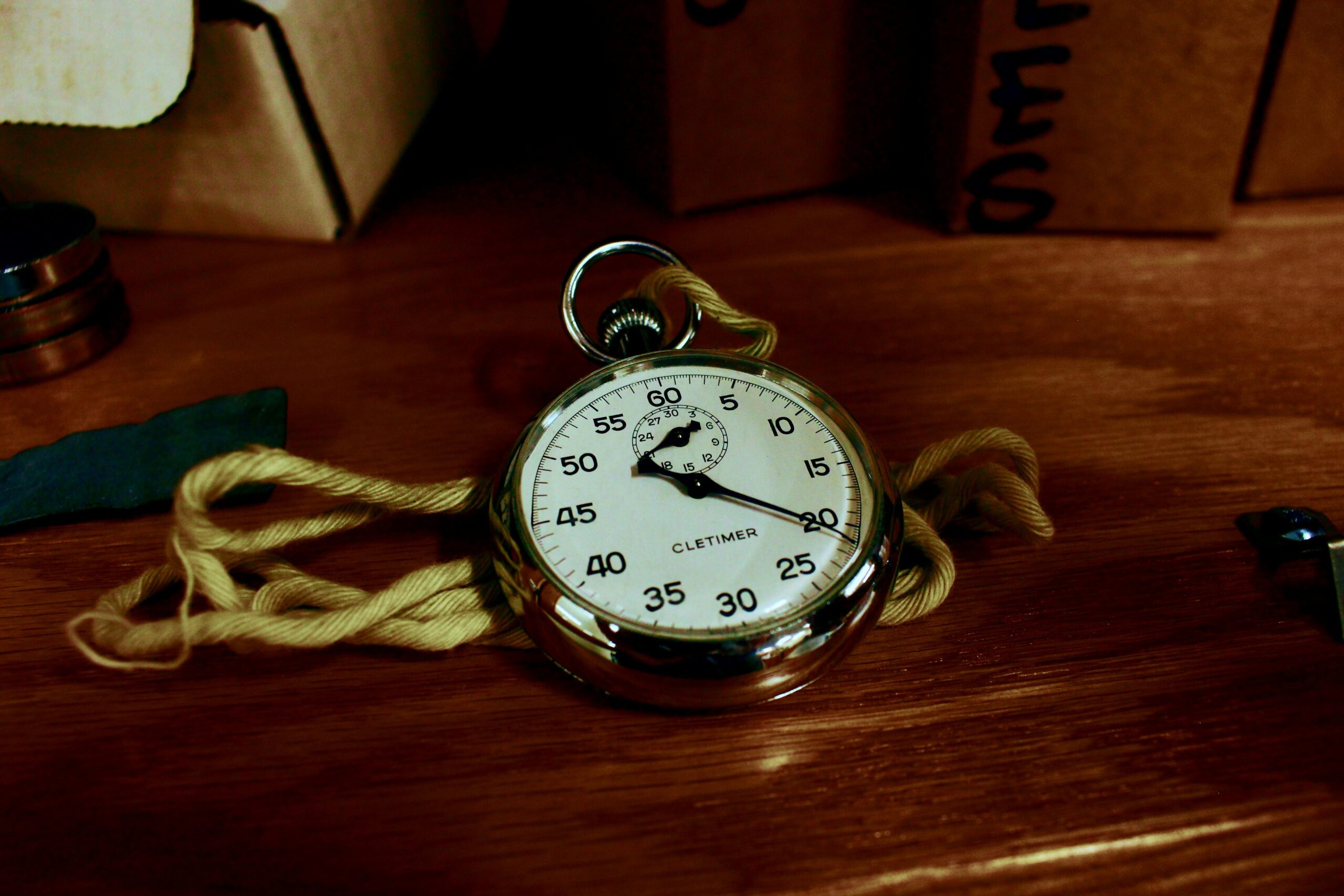 A classic silver watch lying on a wooden table