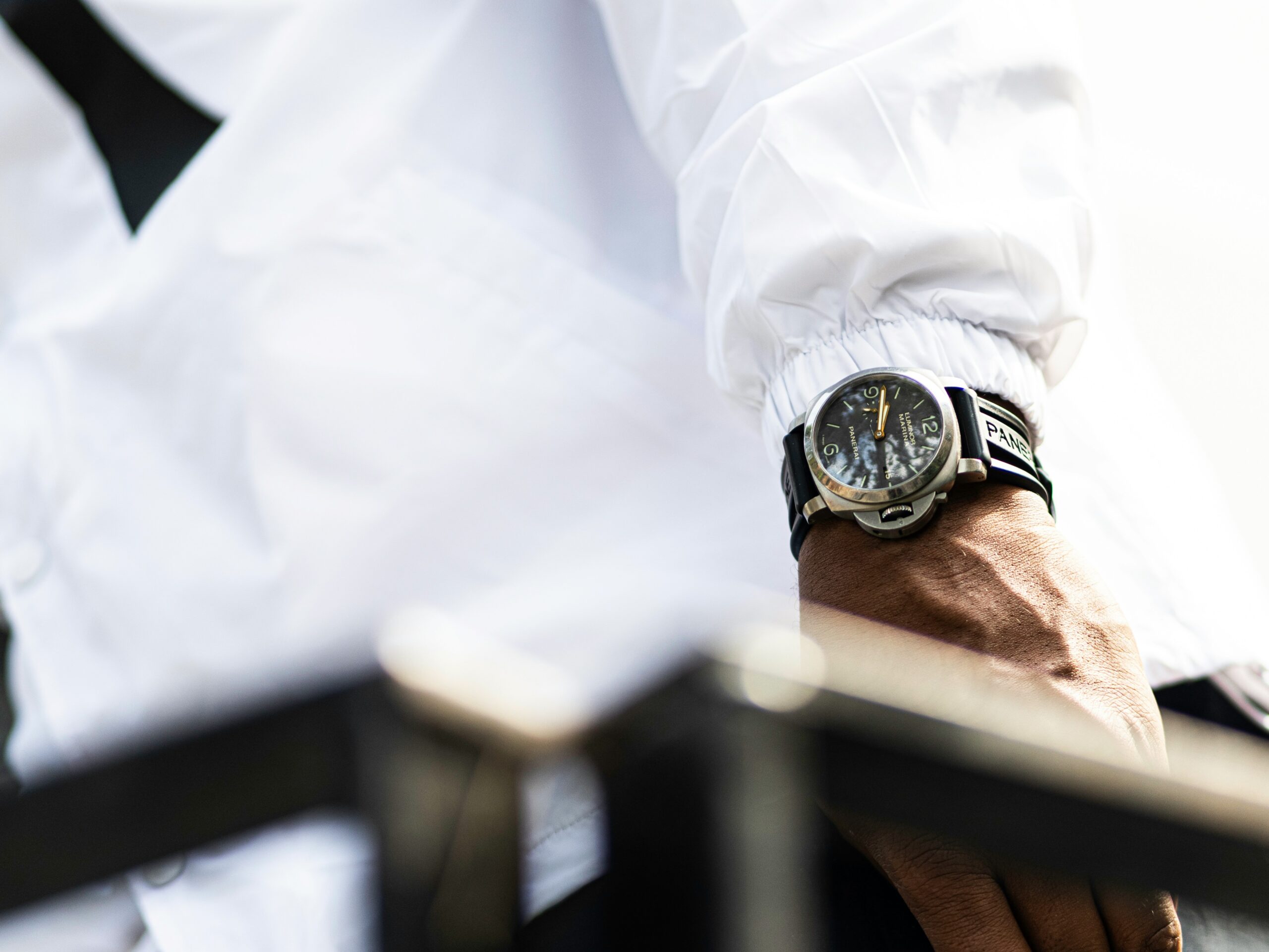 A collage of celebrities such as Ryan Gosling and Emma Watson wearing minimalist monochrome watches