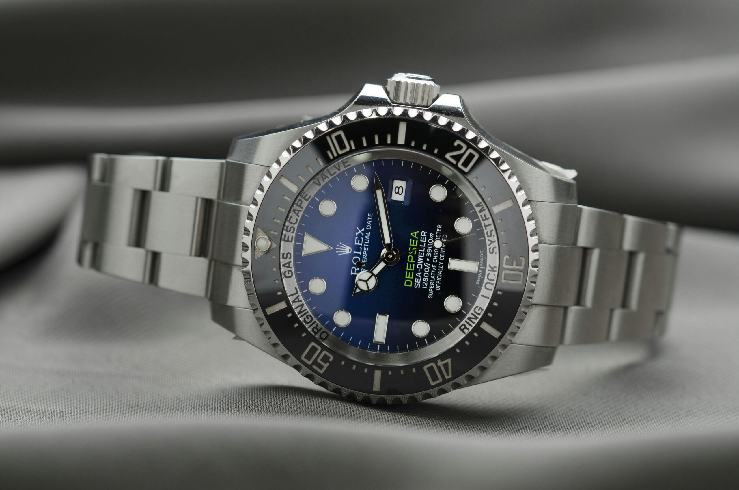 An Apple Watch with a stunning sapphire-blue bezel against a backdrop of fashion sketches