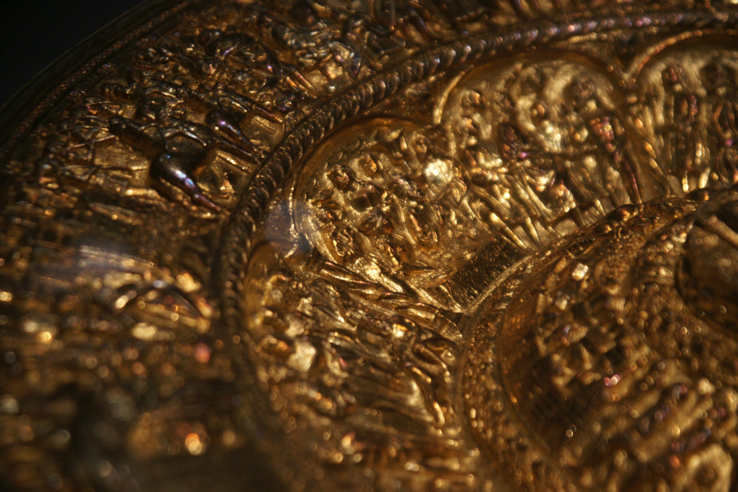 Photo of Sarah holding her gold-plated watch with engraved backplate