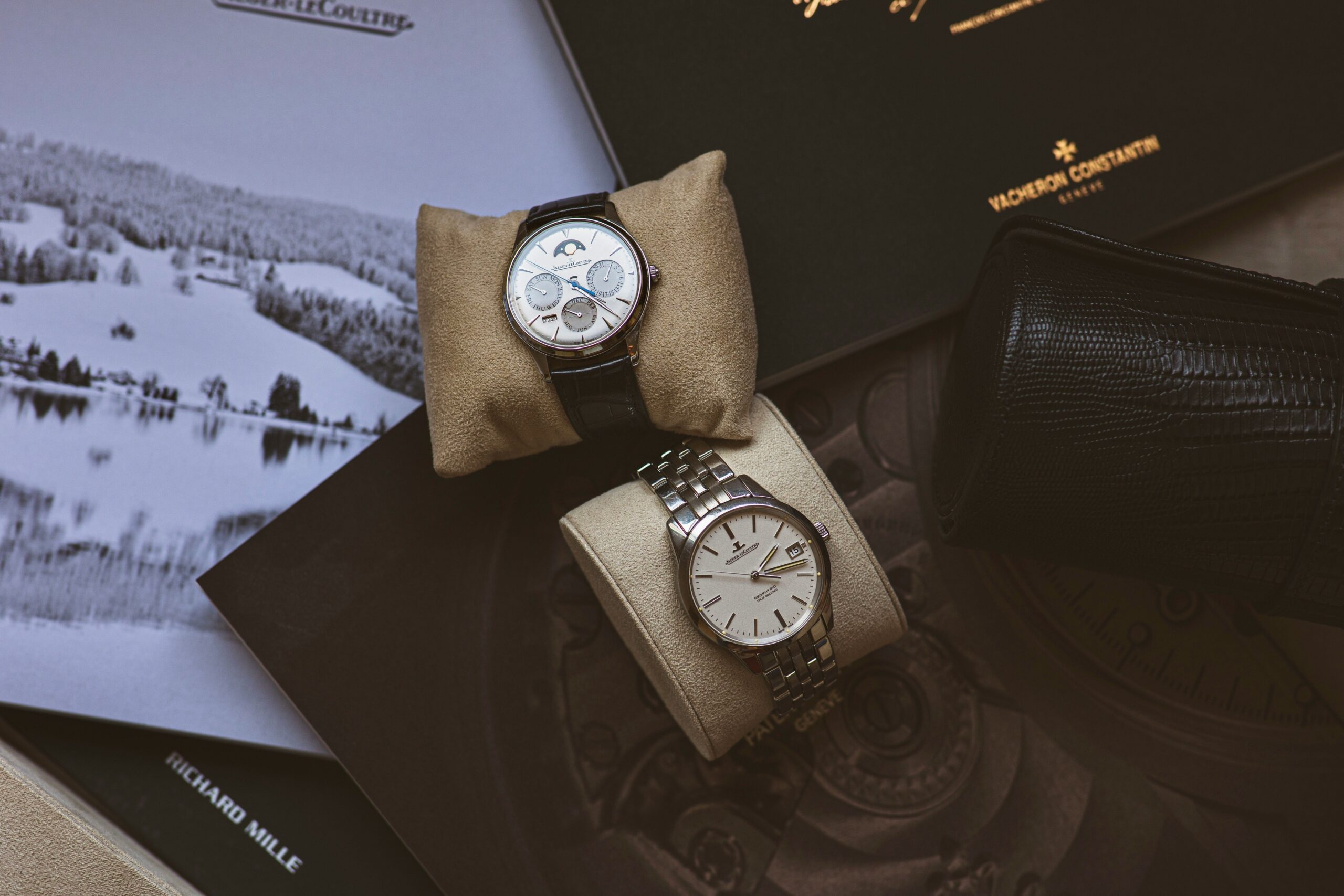 Three neutral-colored watches displayed alongside cozy winter accessories like gloves and scarves.