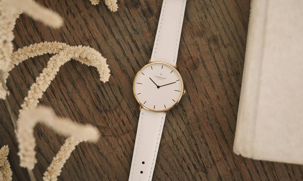 Two side-by-side images showcasing stylish personalized minimalist watches.