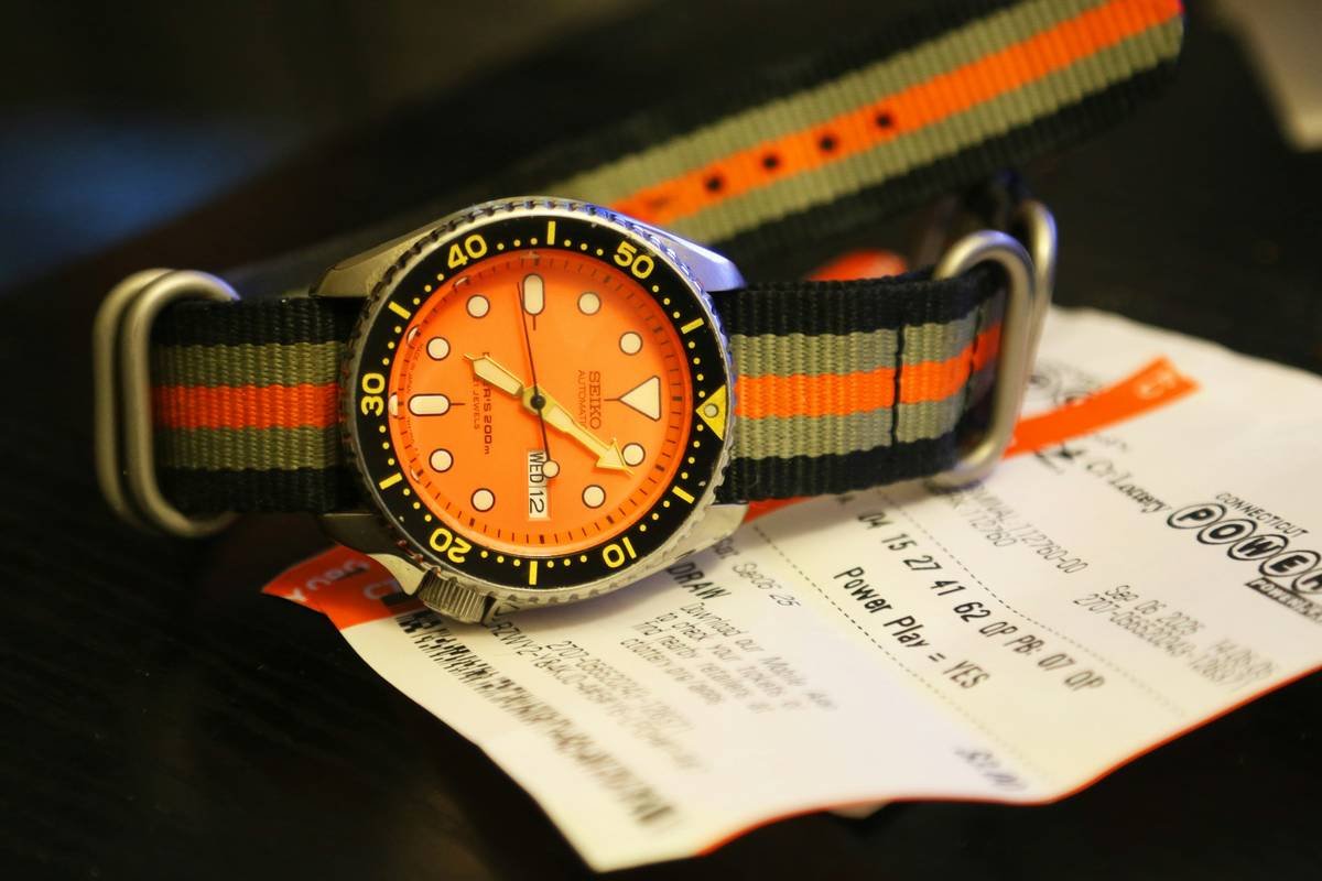 A colorful display of watches featuring bold yellows, oranges, and greens